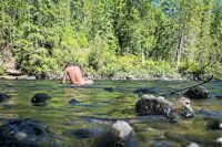 Naked baither in a river